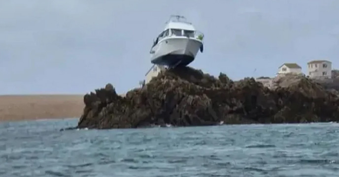 Boat gets stuck 10 feet on top of a rock